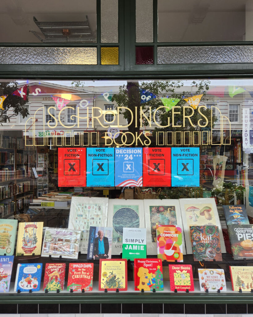 Red and blue election style posters in a bookshop window.